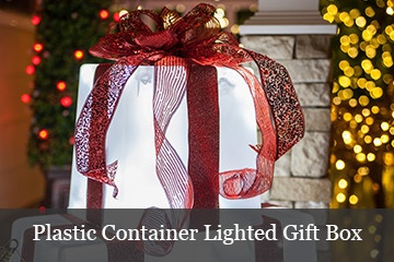 DIY lighted gift boxes using a plastic container, string lights and holiday ribbon.