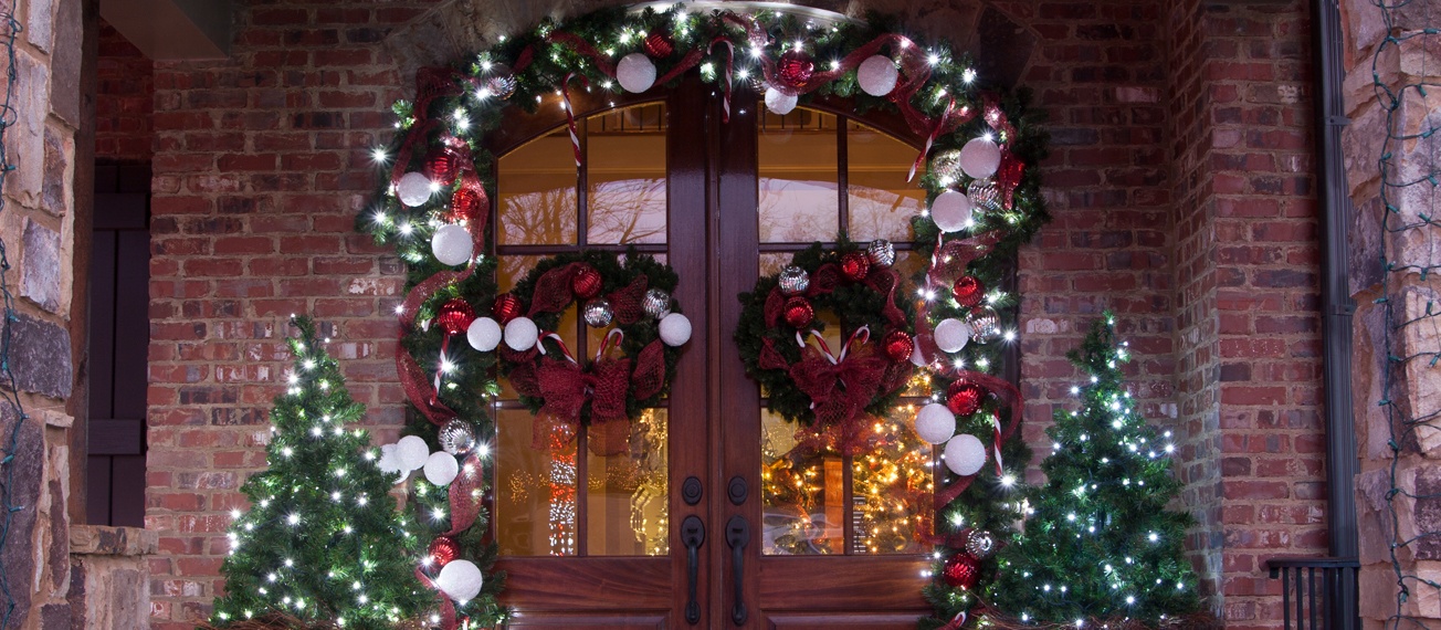 Decorate the front door with Christmas greenery and ornaments.