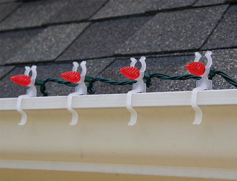 LED all in one light clip hangs mini string lights on gutters.